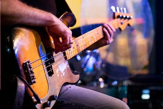pexels photo 36219462 36219462 Detailed close-up of a musician playing a vintage bass guitar during a live performance.