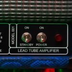 pexels photo 9798757 9798757 Detailed close-up of a lead tube amplifier showing knobs and switches.